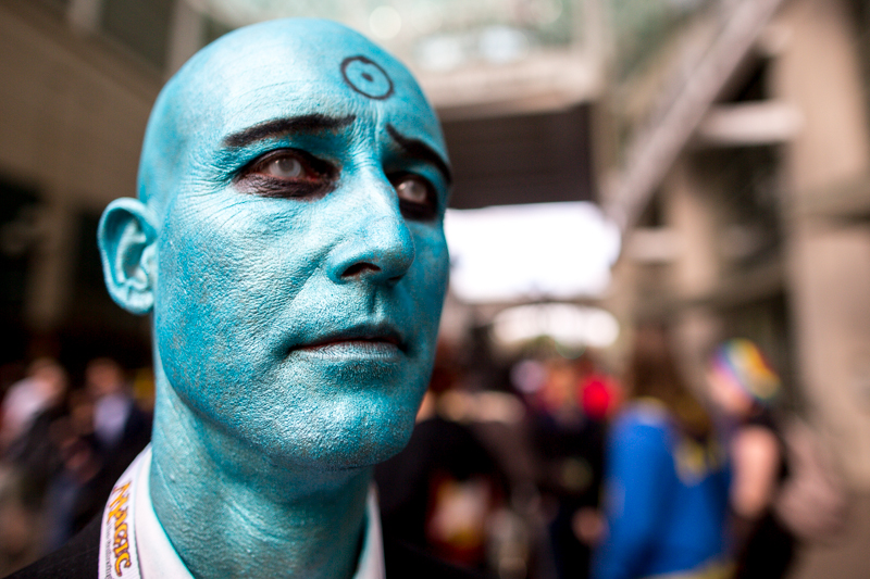 Clad in blue paint, a participant poses for a photo as Doctor Manhattan.