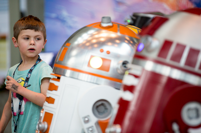 Malcolm, 4-and-a-half, shoots a wary eye to a gaggle of functional R2D2s.