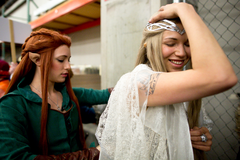 A friend makes an adjustment to Becki Watts' costume as she awaits the beginning of the costume contest.