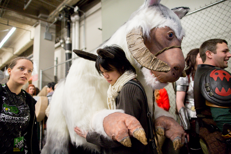 Handlers brace a giant, full-size tauntaun backstage.