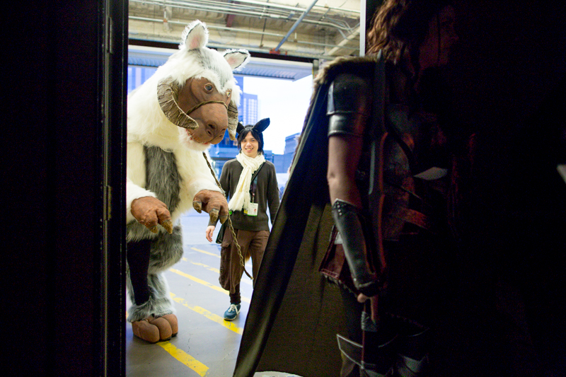 The lifesize tauntaun is carefully guided toward the backstage door.
