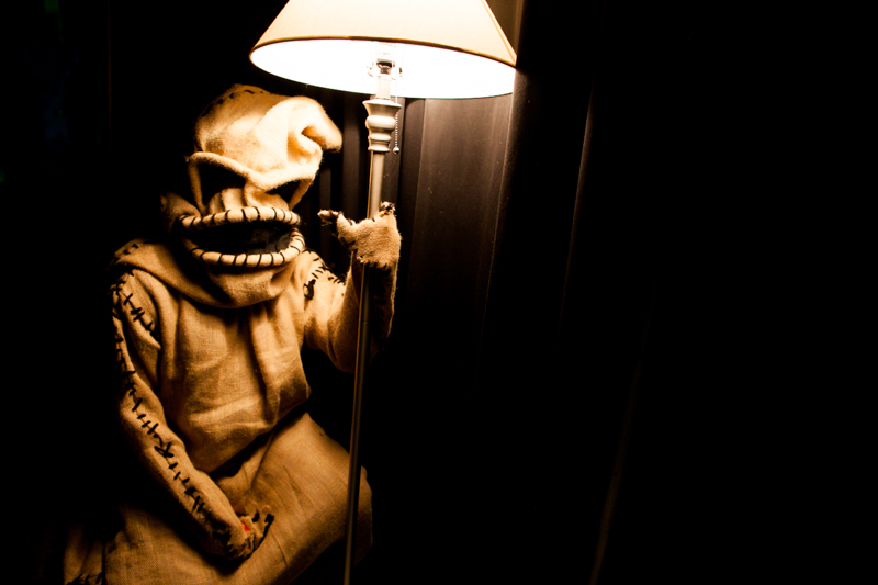 Oogie Boogie from 'Nightmare Before Christmas' rests beside a lone lamp backstage.