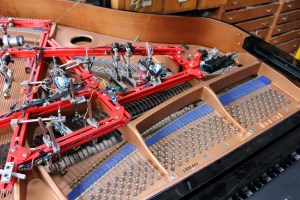 Above: Trimpin (left) and Morlot in rehearsal. Below: the score and the prepared piano.