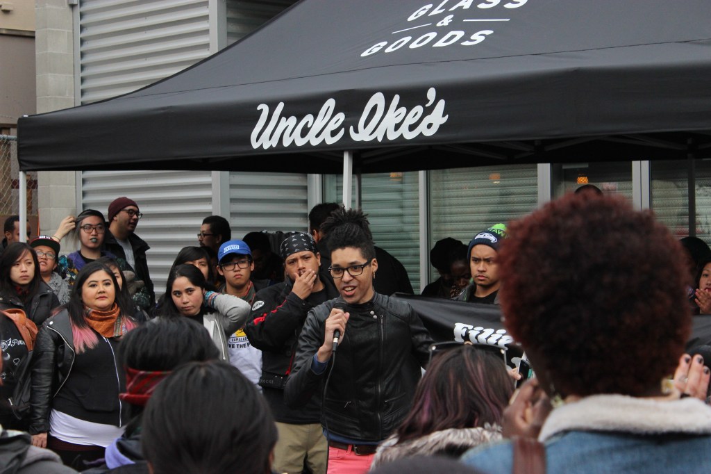 Renee Jarreau Greene speaks to the crowd outside Uncle Ike's. Photo by Casey Jaywork.