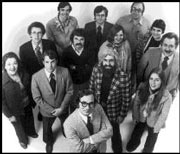 Early Seattle Weekly staff photo with David Brewster in front. Darrell Oldham is directly behind Brewster, also with crossed arms.
