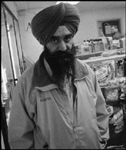 Mann on the street: Gurdev Singh Mann worries that Sound Transit's bulldozers will raze his business.