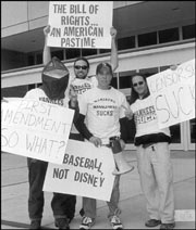 Mr. Villano (with megaphone), a lizard (far left), and two others stand up for "suck."