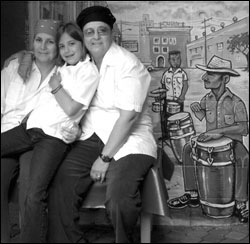 Miriam, Ally, and Angela get close on Mamey's patio.