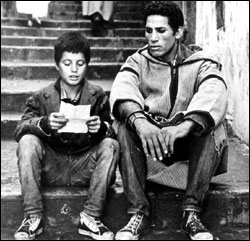 A FLN courier (Mohamed Ben Kassen, left) reads instructions to illiterate Haggiag.