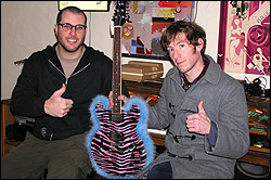 Darrin Wiener, left, and the Vells' Tristan Marcum with the infamous pink pleather guitar.