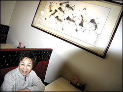 Mabel, aka "Sexy Li," watches over Chiang's big, red dining room.