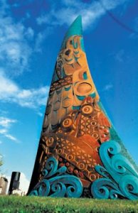 Marvin Oliver's Spirit of Our Youth orca fin rises from a park in the Central District.