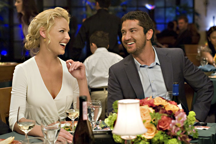 Heigl discovers where Butlers hand went beneath the table.