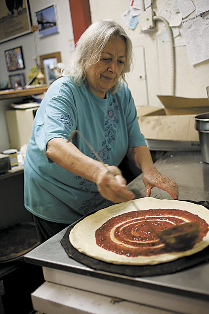 Relita Ventura swirls on the sauce.