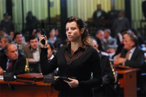 The older Rita (D'Agostino) testifies in court.
