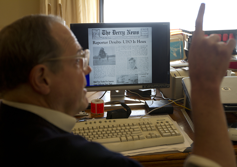 Davenport in front of a computer image of his first article on UFOs, published in 1965.