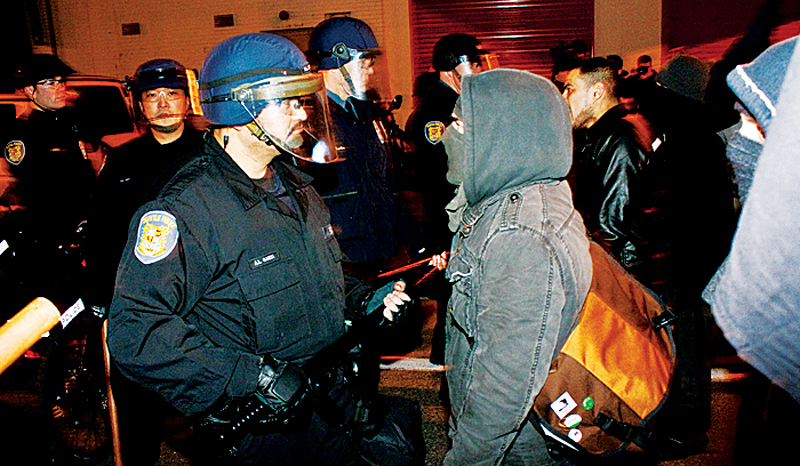 An angry protester faces an officer near Capitol Hill's East precinct on Feb. 18. The protester repeatedly hurled insults and challenged the officer to hurt him.