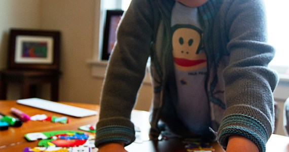 Tino at home, putting together a puzzle.