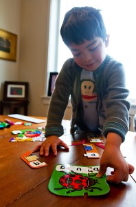 Tino at home, putting together a puzzle.