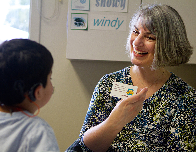 Kristina Udall shows her son Tino a flash card at one of his therapy sessions.