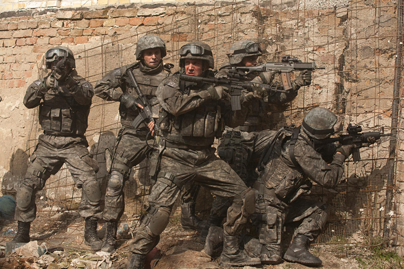 Fiennes (at center) adds bullets to the Bard.