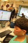 CNA Cynthia Y. Johnson searches her screen for beds.International Film Circuit