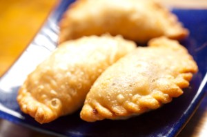 Plump puff pastries—folded into twisty-edged crescents stuffed with mushrooms, tofu, peas and carrots—are each exactly the same size as the next.