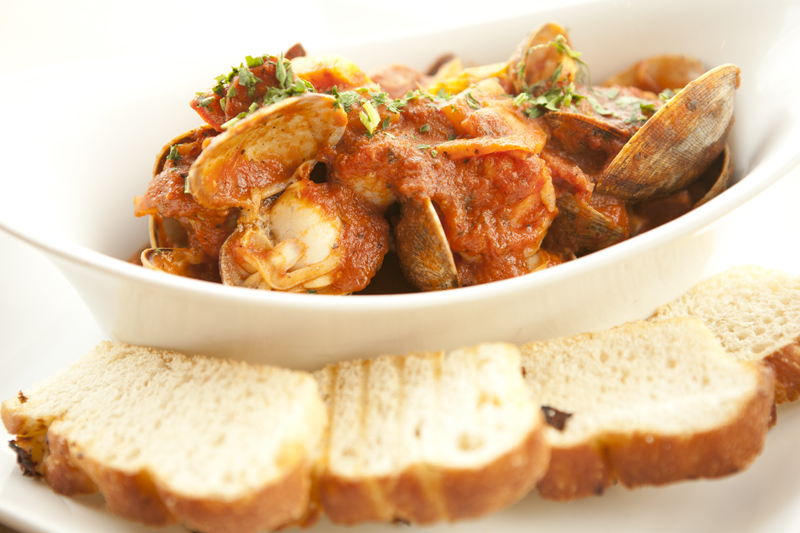 A stew of shrimp, scallops, Portuguese sausage and clams is made riveting by a zesty tomato sauce propped up by fennel and smoked pepper.
