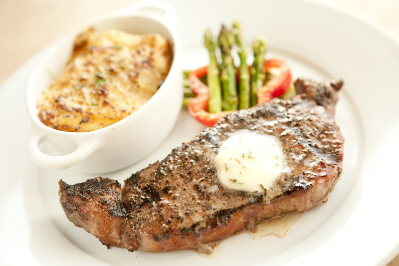The steak, for example, is a convincing battle cry on behalf of meat and potatoes. The plate's only concession to fashion is an accompanying cluster of trendy cauliflower blooms, softened, buttered and—lest eyelids droop at the sight of so much white—interspersed with neatly trimmed slivers of sweet red pepper. A loop-handled crock burbles with a thickly-cheesed, hand-cut potatoes au gratin that resembles the aEœbeforeaE image in healthy cooking magazines that purge recipes of calories and fat. Broiler-crisped around the edges, the gratin has a sharp, rich flavor that plays off the centerpiece bow tie of beef. The remarkably juicy steak wears an ankle-deep crust of black pepper that Rodriguez would surely call her aEœflair.aE It's terrific.