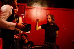 Backstage, contestants pick numbers from a hat to determine their performance order.