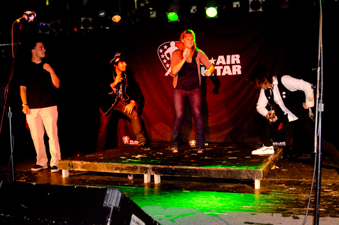 Just because you don't show up to be in the show doesn't mean you won't be. Here, two audience members play in an Air Band to kick off the competition.