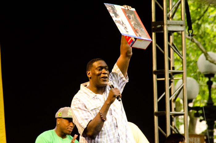 Shawn Kemp holds up a collectable figurine of himself (from the 1997 season with the Sonics) that a fan handed to him.