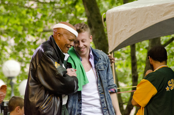 Macklemore meets Slick Watts on stage during the final minutes of the rally.