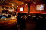 Manhattan Drugs has the opulent brothel look of an urban steakhouse. Like a Metropolitan Grill for the biodiesel generation, the restaurant is furnished with hulking wooden booths, upholstered leather chairs and light fixtures fashioned from pipes.
