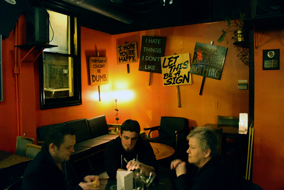 The only open spot in this joint was in the back, away from everyone else.