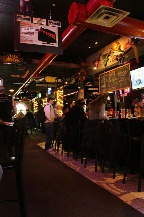 Other Rocksport patrons hang out and watch the game enjoying beverages.