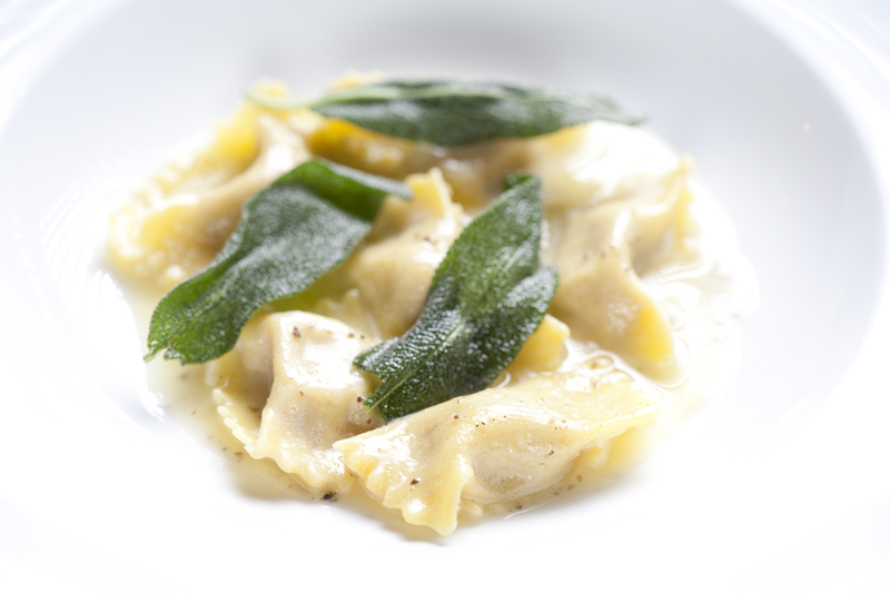 Duck agnolotti, with black truffle butter, and crispy sage.