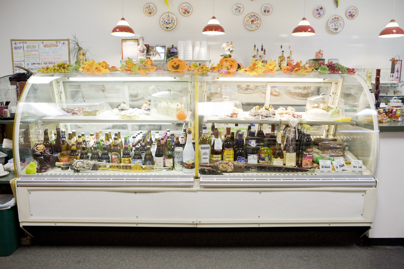 Deli cases installed by the previous owner, now house a dozen homemade cakes and German beer.