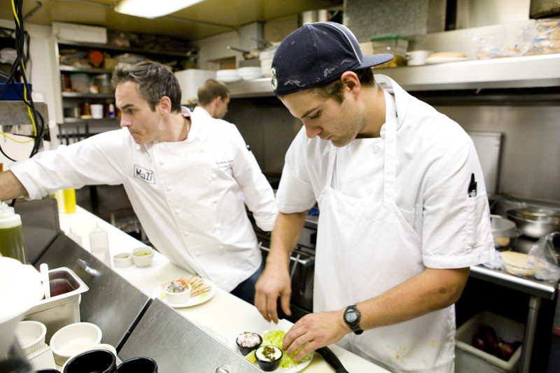 Line cook, Chris and executive chef Jonathan, platting dishes for hungry customers.