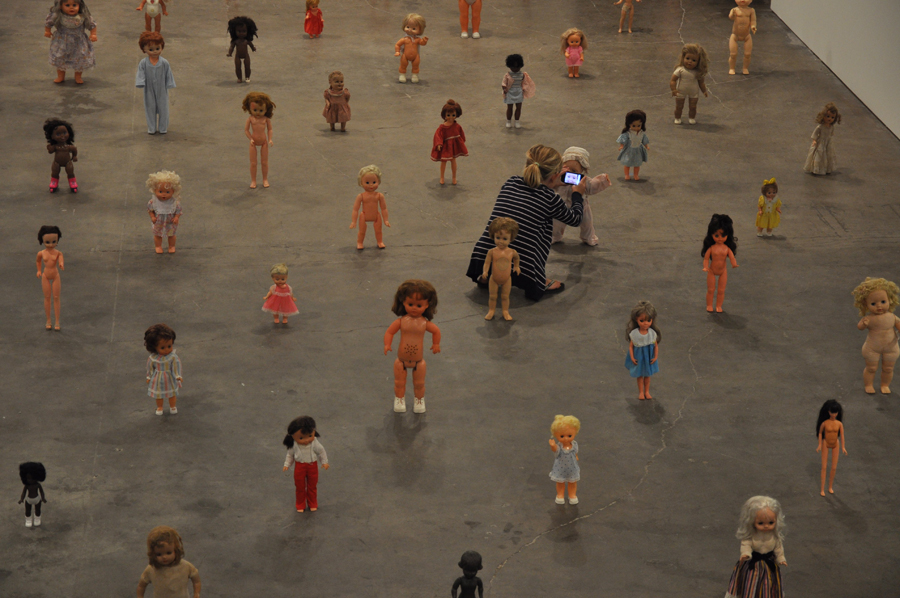 A young girl is almost lost amidst the visual onslaught of tiny girls.