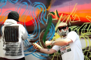 Sensei23 and Smurf work on a mural.