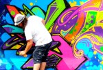 Dan Primo creaes a complex colorful painting on the 619 wall.