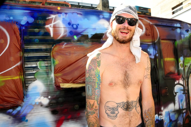 Artist Quincy Quigg paints a van for Teeter Totter, a Seattle band.