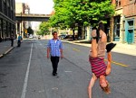 Choreographer Bobby Bonsey and Jonatan Ortiz practice  a hat move on the street in front of 619 Western.