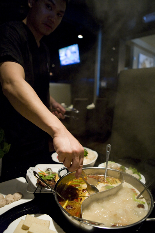 Steve Yang demonstrating how to start things at Little Sheep Hot Pot.