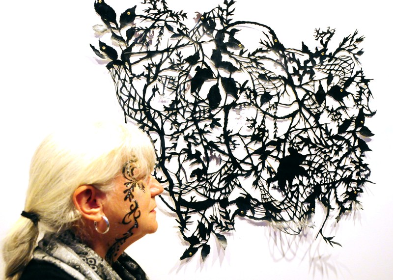 Catherine with her elegant face painting for Artopia, in front of a sculpture by Allyce Wood.