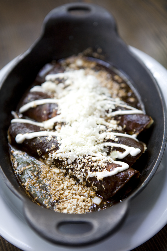 Chicken Mole Enchilada: Mad Hatcher free range chicken & traditional oaxacan mole negro, topped with diced onion, crema & cotija cheese.