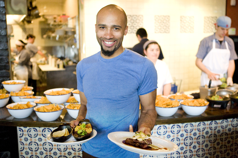 Did someone say Carne Asada? Server Jessie Lee gets on his way to serving customers at Poquitos.