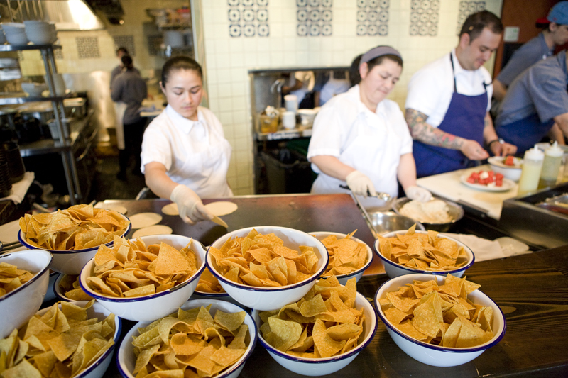 Warming the house made tortillas and making chips.