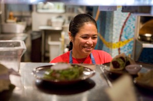 Owner and chef Maria Hines runs the expo window at her restaurant.